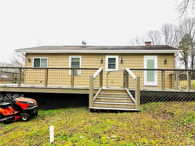 rear view of property featuring a deck