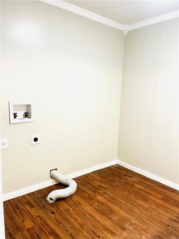 clothes washing area with hookup for an electric dryer, crown molding, hardwood / wood-style flooring, and washer hookup