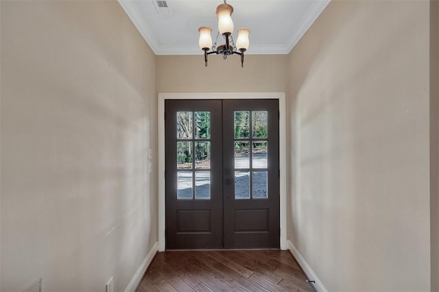 doorway with crown molding, french doors, hardwood / wood-style floors, and a notable chandelier