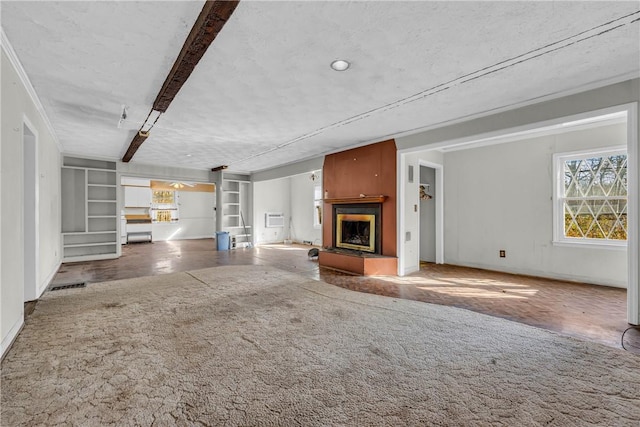 unfurnished living room featuring an AC wall unit, carpet flooring, and a textured ceiling