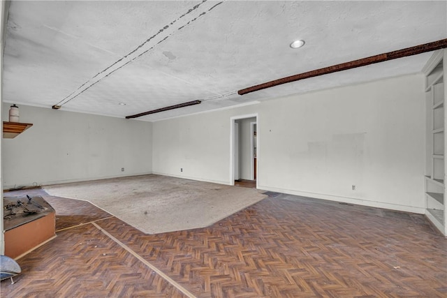 interior space with dark parquet floors and a textured ceiling