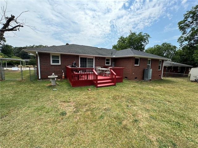 rear view of property with a wooden deck and a yard