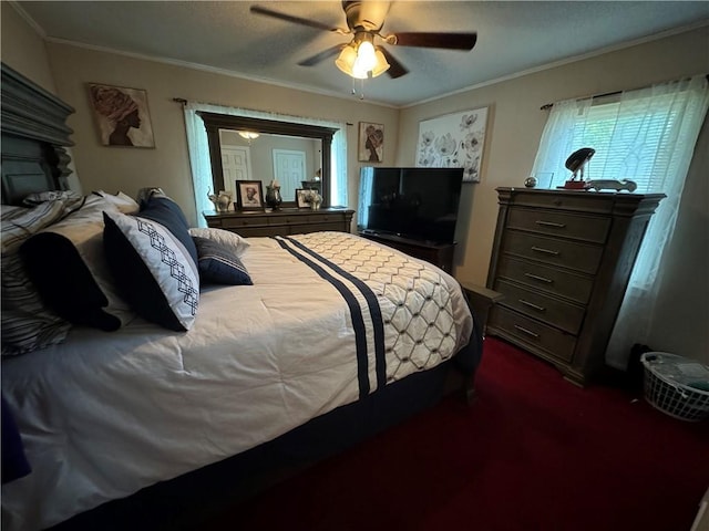 bedroom featuring dark colored carpet, a textured ceiling, ceiling fan, and ornamental molding