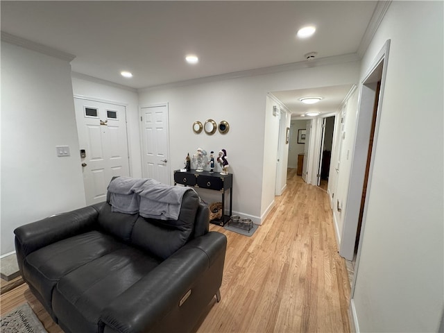 living room with light hardwood / wood-style flooring and ornamental molding