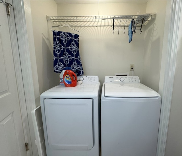 clothes washing area featuring washer and clothes dryer