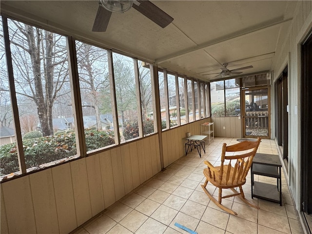 sunroom featuring ceiling fan