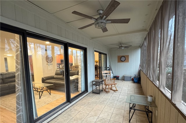 sunroom featuring ceiling fan