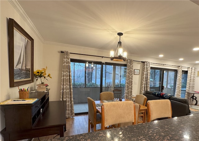 dining space featuring crown molding, dark hardwood / wood-style flooring, and a healthy amount of sunlight