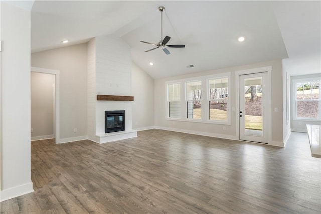 unfurnished living room featuring ceiling fan, a fireplace, high vaulted ceiling, and dark wood-type flooring