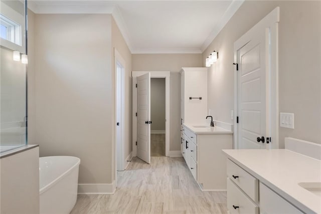 bathroom with vanity, a bath, and ornamental molding