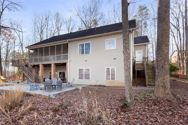 rear view of house with a sunroom and a patio area