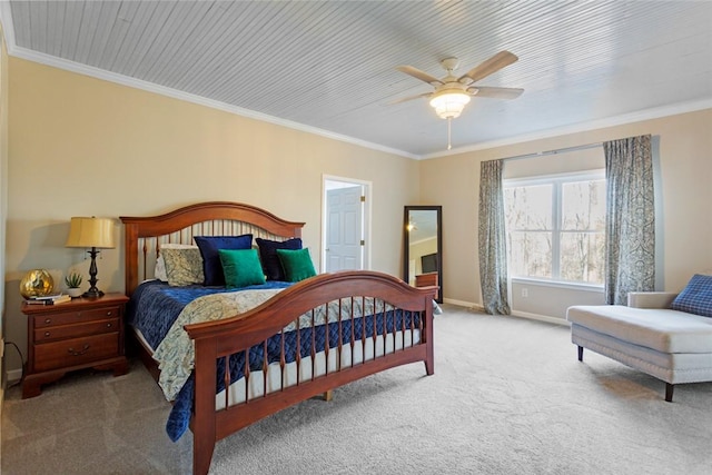 carpeted bedroom with ceiling fan and ornamental molding