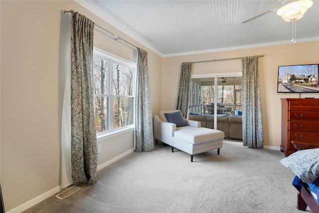 carpeted bedroom featuring multiple windows, ceiling fan, and ornamental molding