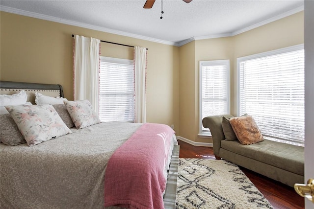 bedroom featuring ceiling fan, dark hardwood / wood-style floors, and crown molding