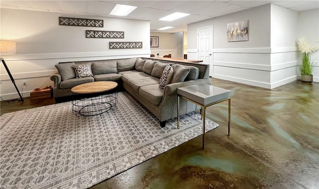 living room with a paneled ceiling