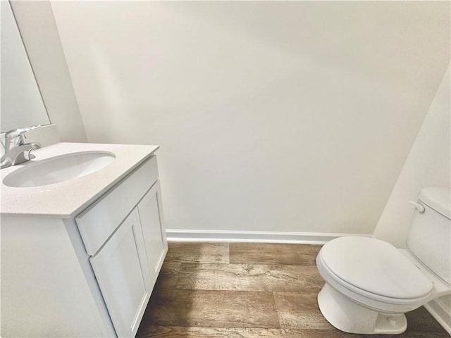 bathroom featuring vanity, toilet, and wood-type flooring