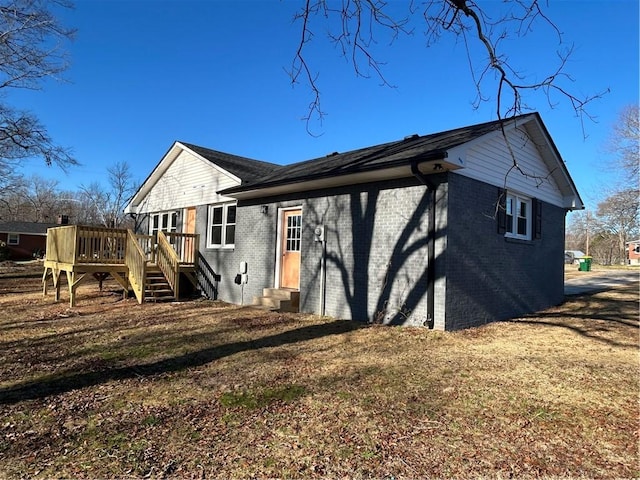 back of house with a wooden deck and a yard