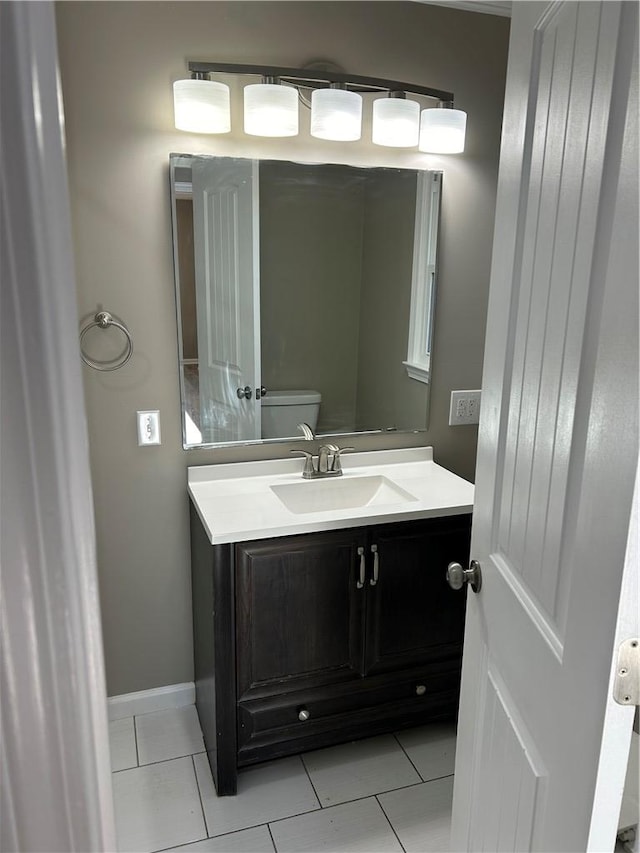 bathroom featuring vanity, tile patterned floors, and toilet