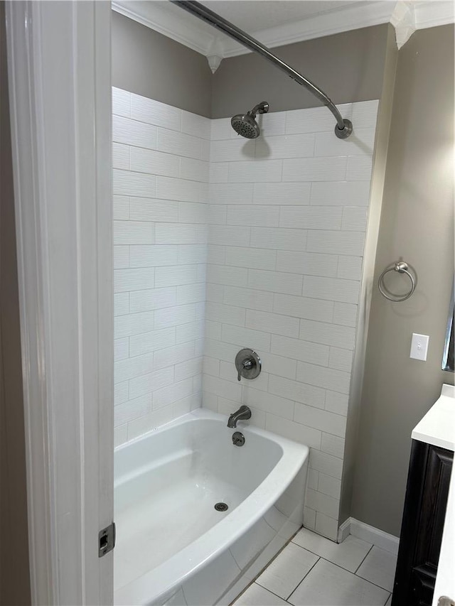 bathroom featuring vanity, crown molding, tile patterned floors, and tiled shower / bath