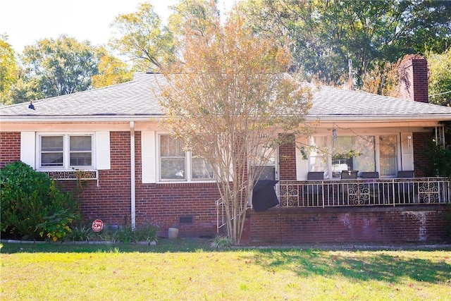 rear view of house with a porch and a yard