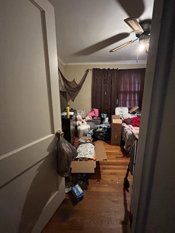 bedroom featuring ceiling fan, hardwood / wood-style flooring, and crown molding