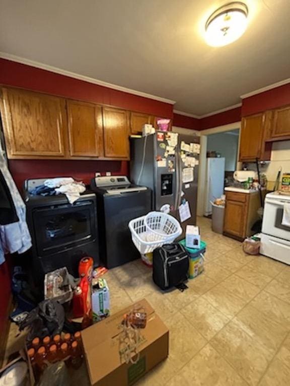 kitchen with stainless steel fridge, washer / dryer, and crown molding