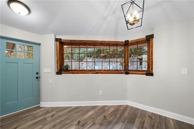 entrance foyer featuring wood-type flooring and an inviting chandelier