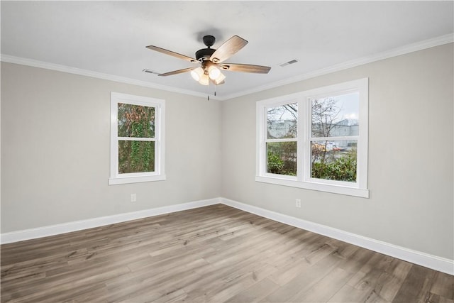 unfurnished room featuring ceiling fan, light wood-type flooring, and ornamental molding