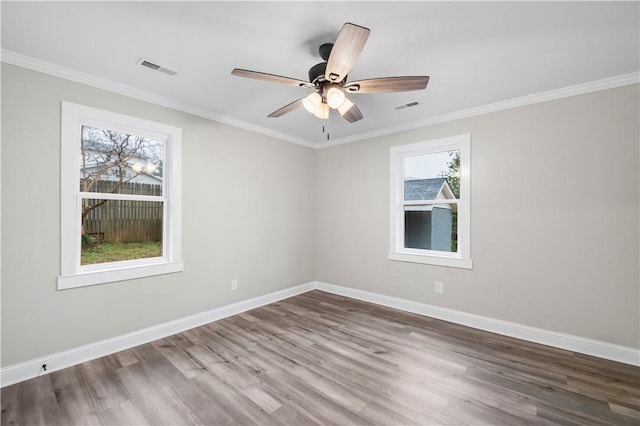 unfurnished room featuring hardwood / wood-style floors, ceiling fan, and crown molding