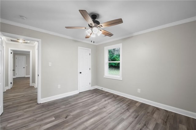 unfurnished bedroom featuring hardwood / wood-style flooring, ceiling fan, and crown molding