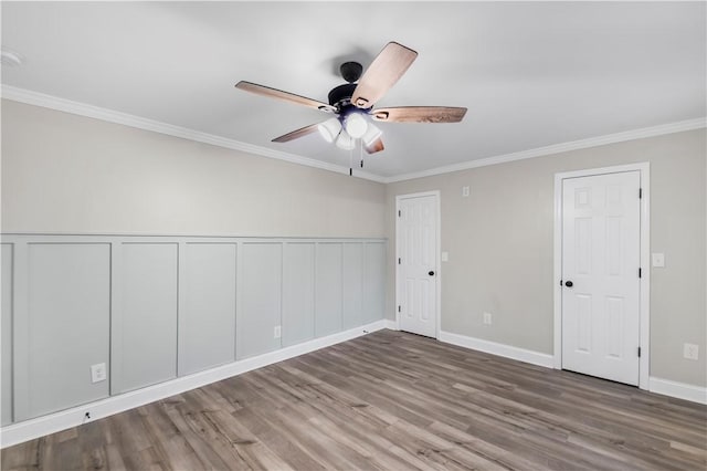 unfurnished room with ceiling fan, wood-type flooring, and ornamental molding