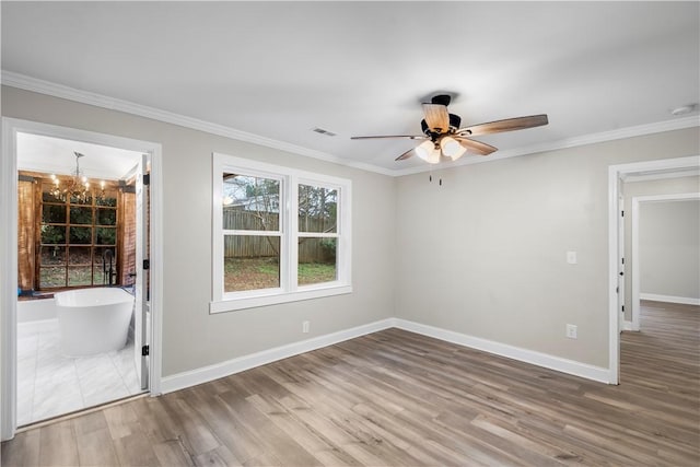 spare room with hardwood / wood-style floors, ceiling fan with notable chandelier, and ornamental molding