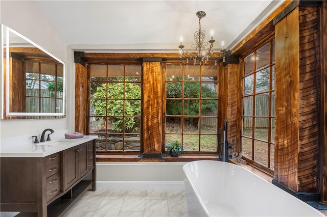 bathroom with vanity, a tub, and a notable chandelier