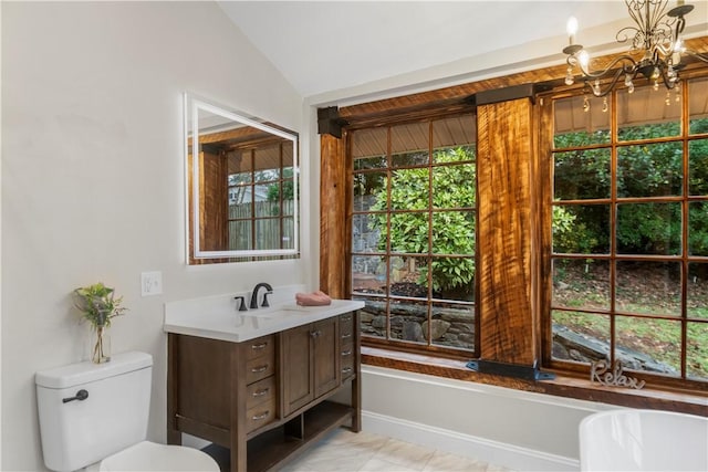 bathroom featuring vanity, an inviting chandelier, and lofted ceiling