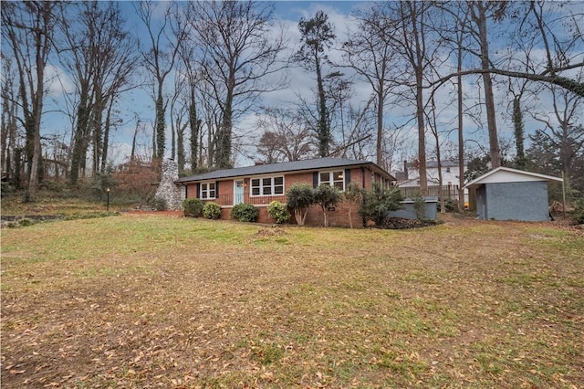 ranch-style house with a front lawn and a storage shed