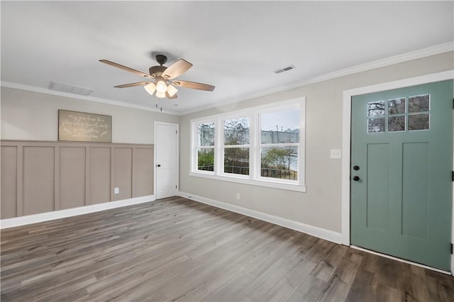 foyer with hardwood / wood-style flooring, ceiling fan, and crown molding