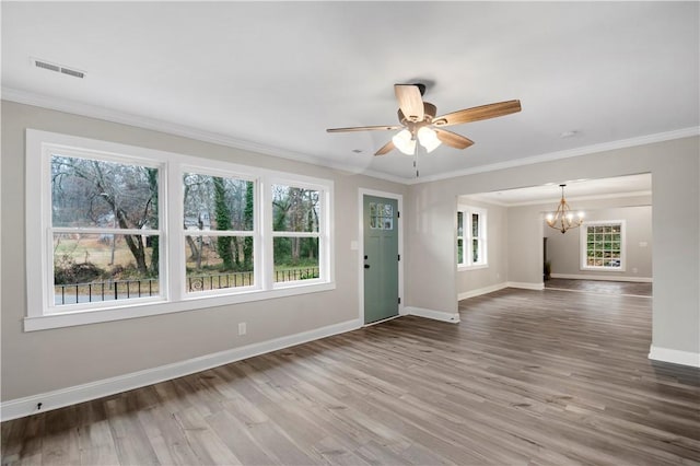 interior space with ceiling fan with notable chandelier, wood-type flooring, and ornamental molding