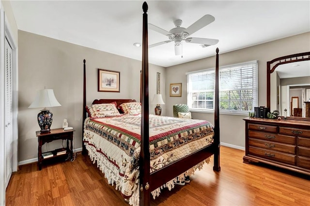 bedroom with hardwood / wood-style floors, ceiling fan, and a closet