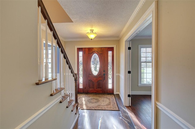 foyer featuring a textured ceiling, crown molding, and dark hardwood / wood-style floors