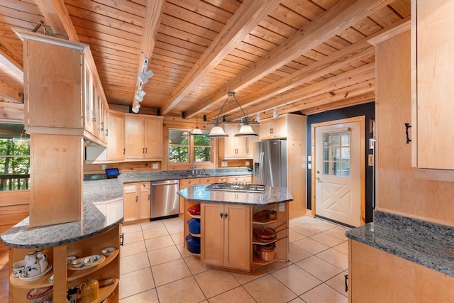 kitchen featuring a center island, rail lighting, light brown cabinetry, appliances with stainless steel finishes, and beamed ceiling