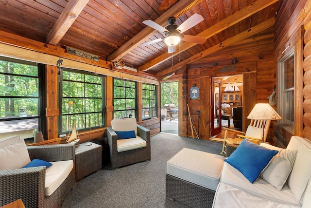 living room featuring wood walls, lofted ceiling with beams, carpet flooring, ceiling fan, and wood ceiling