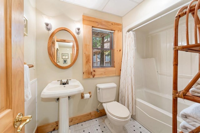 full bathroom with sink, shower / bathtub combination with curtain, and toilet