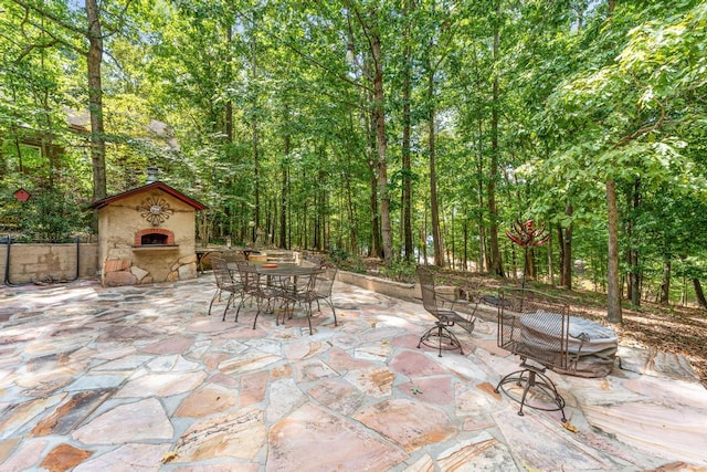 view of patio / terrace featuring an outdoor stone fireplace