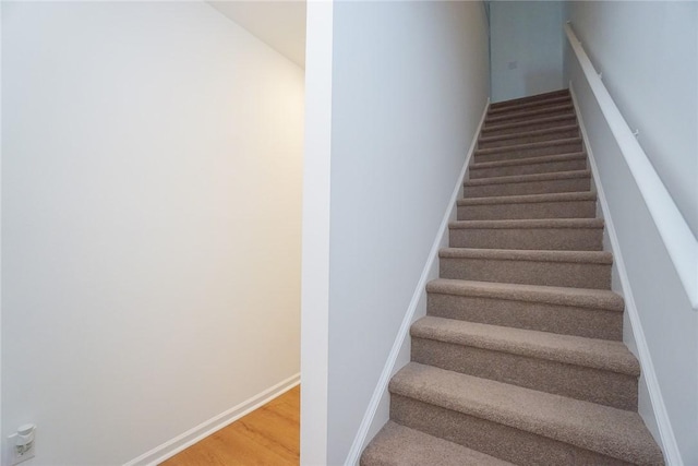 stairs with hardwood / wood-style floors