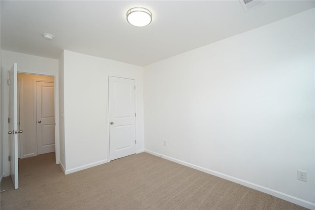 unfurnished bedroom with light colored carpet