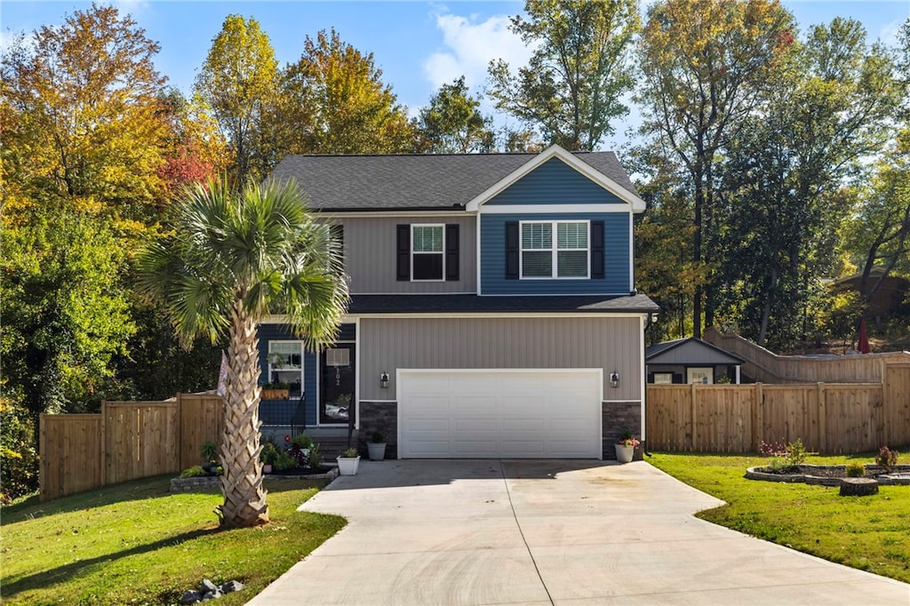 view of front of home featuring a garage and a front yard