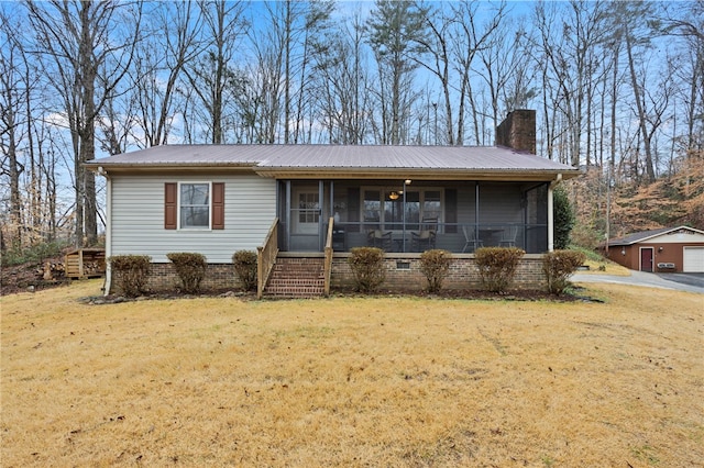 view of front of home with a sunroom and a front lawn