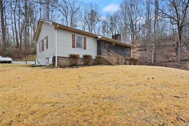 view of front of property featuring a sunroom and a front yard