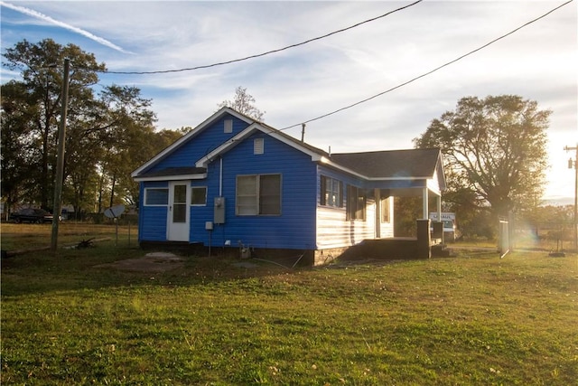 view of side of home featuring a lawn