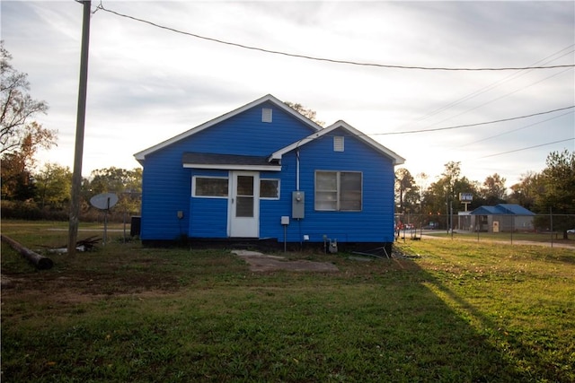 rear view of property with a yard